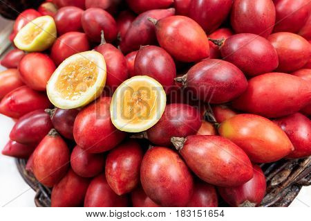 Traditional market stall full of fresh red maracujas