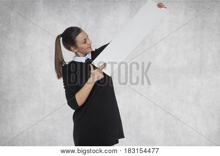 Beautiful girl points to your advertisement, copy sopace