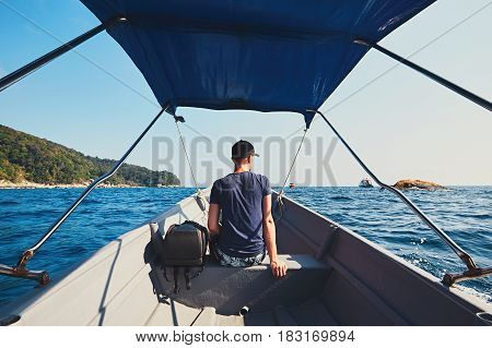 Adventure on the sea. Young man traveling by motorboat.