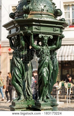One of the drinking antique Wallace fountains with women group sculpture on in Paris