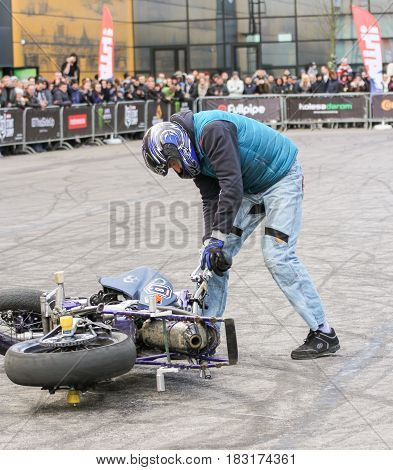 St. Petersburg Russia - 15 April, A biker near a fallen motorcycle,15 April, 2017.
International Motor Show IMIS-2017 in Expoforurum.
Sports motorcycle show of bikers on the open area.