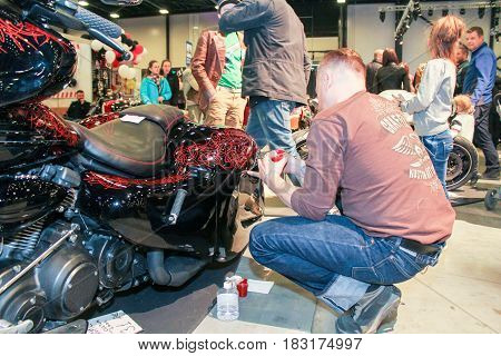St. Petersburg Russia - 15 April, An artist painting a motorcycle motif,15 April, 2017.
International Motor Show IMIS-2017 in Expoforurum.
Visitors and participants of the annual moto-salon in St. Petersburg.