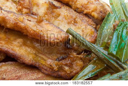 Closeup To Fried Bananas And Pandan Leaves Background