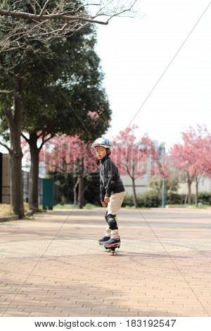 Japanese Boy Riding On A Casterboard (first Grade At Elementary School)