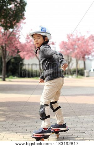 Japanese Boy Riding On A Casterboard (first Grade At Elementary School)