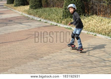Japanese Boy Riding On A Casterboard (first Grade At Elementary School)