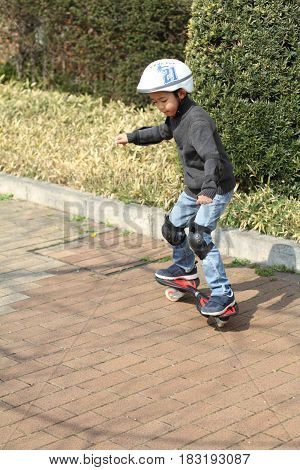 Japanese Boy Riding On A Casterboard (first Grade At Elementary School)