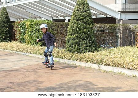Japanese Boy Riding On A Casterboard (first Grade At Elementary School)