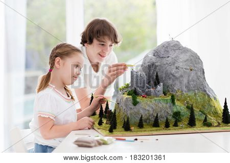 Kids Working On Model Building Project For School