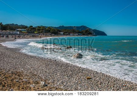 Summer vacationers on the beach of Portonovo, Monte Conero, Italy