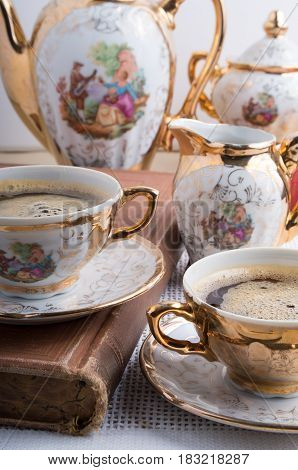 Antique porcelain coffee cups with hot espresso and tableware from the 19th century German Bavaria
