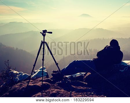 .  Man Takes Photos With Mirror Camera On Peak Of Rock. Dreamy Fog