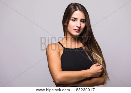 Portrait Of Beautiful Brunette Woman In Black Dress On Grey Background