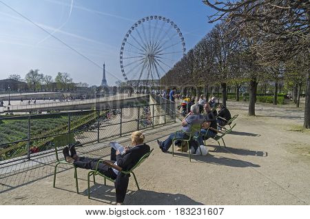 PARIS FRANCE - MARCH 26 2017: People are resting in the Tuileries garden on a spring sunny day. Paris France.