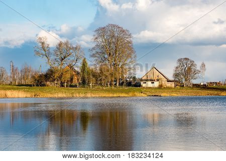 Reflections Of Coutry House In The Lake Water