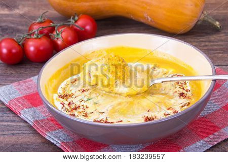 Pumpkin puree with saffron and meatballs. Studio Photo