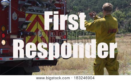 Fire fighter helping fire truck back up on road in response to wildfire