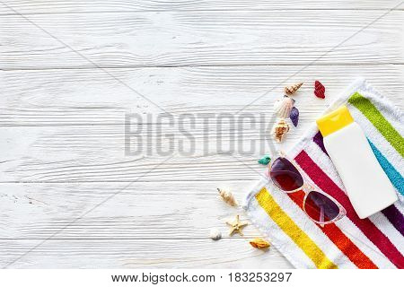 Summer Vacation Concept Flat Lay. Colorful Towel, Sunglasses, Yellow Sunscreen And Star Shells On Wh