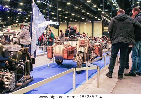 St. Petersburg Russia - 15 April, A group of men at a motorcycle,15 April, 2017.
International Motor Show IMIS-2017 in Expoforurum.
Visitors and participants of the annual moto-salon in St. Petersburg.