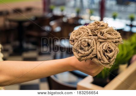 Bouquet of artificial beautiful grey roses made of burlap