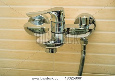 Close-up image of modern chrome tap and sink