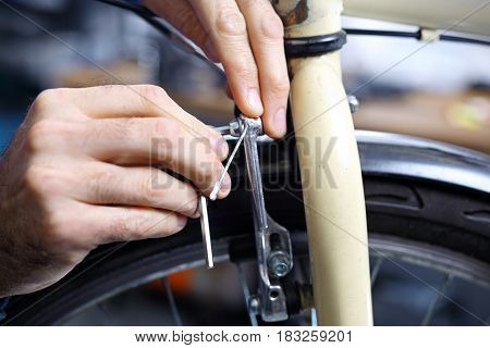The man exchanges the brake pads on the bike