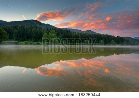 Summer Sunrise on Moutnains Lake, colorful clouds and reflection, Freizeitsee Zenz, Austria, Europe