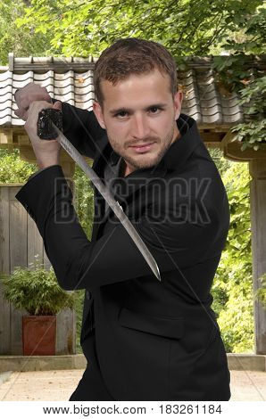Young man with a samurai bushido katana sword