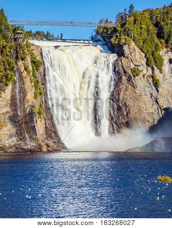  Montmorency Falls Park, close to the center of Old Quebec. Waterfall Montmorency. Sunny autumn day. The concept of active and cultural tourism