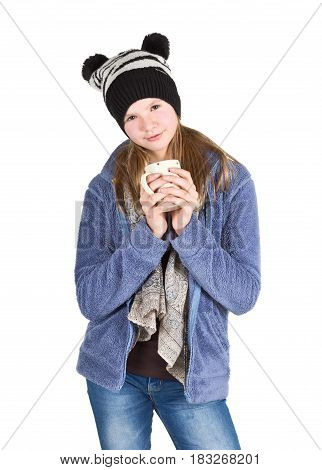 Young girl with jacket and wooly hat holding cup isolated on white background