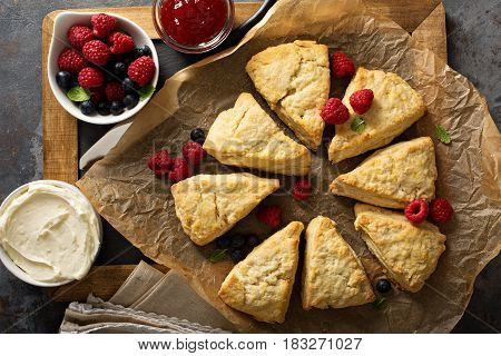 Freshly baked homemade scones with cream cheese and fruits