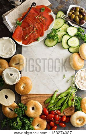 Big breakfast platter with cream cheese, bagels, smoked salmon and vegetables with copyspace