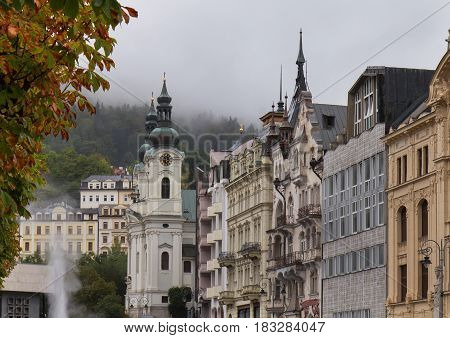 Autumn street in Karlovy Vary (Karlsbad) Czech Republic with Church of St. Mary Magdalene