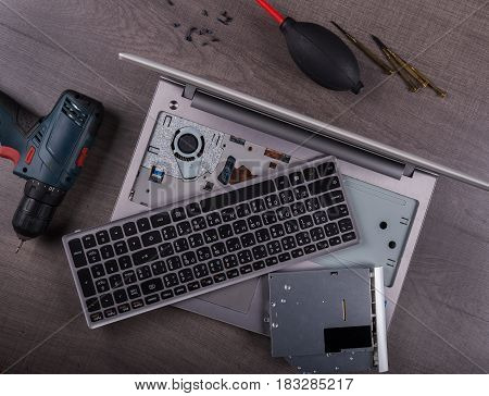 Computer Notebook With Coponent And Tool (repair Concept) On Wood Background