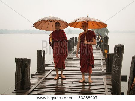 Buddhist Monks Walking On Ubein Bridge