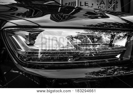 BERLIN - JUNE 14 2015: Headlamp of a full-size luxury crossover SUV Audi Q7 3.0 TDI quattro. Black and white. The Classic Days on Kurfuerstendamm.