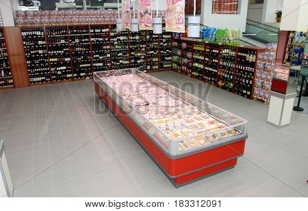 ROME, ITALY. March 26, 2014: Wine shelves and refrigerator with the meat inside a new market (M.A. Supermarket) opening in Rome, Italy.