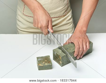 Man Cutting A Handmade Soap With A Knife