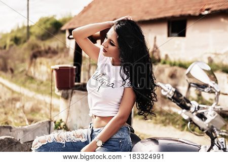 Beautiful Motorcycle Brunette Woman With A Classic Motorcycle (cinema Bleach Bypass Effect)