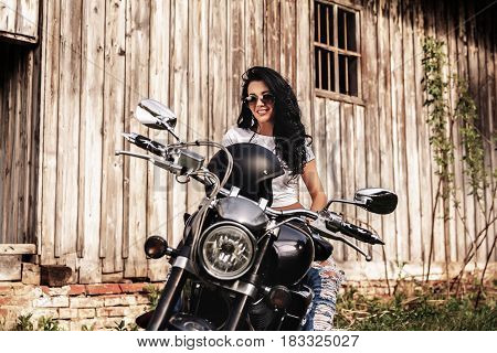 Beautiful Motorcycle Brunette Woman With A Classic Motorcycle (cinema Bleach Bypass Effect)