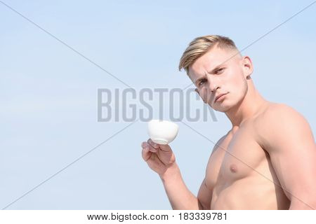 Man Holding Cup Of Coffee On Sky Background, Serious Face
