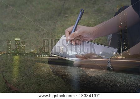 double exposure women writing at filed and night city