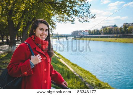 Portrait of happy smiling woman standing near the city river Uzhgorod