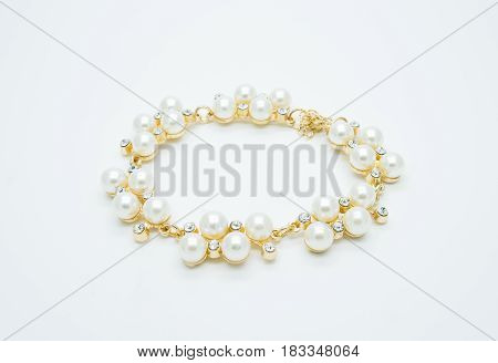 on a white background lies a pearl necklace on the neck and bracelet precious as a gift beloved woman