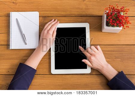 Top view businesswoman touch screen of tablet in office. Freelancer working with portable computer with copy space on display
