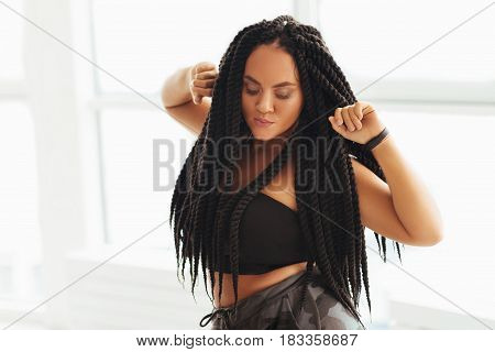 Feminine energy. Confident curvy remarkable lady spending time in studio practicing her movements before a performance on big stage