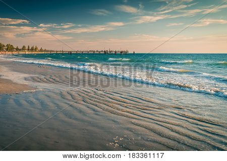 View at Glenelg Beach jetty with people on a warm day South Australia