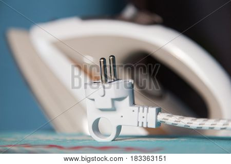 white electric iron cable plug close uo