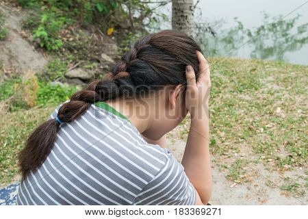 women feeling stressed out about problem at park outdoor