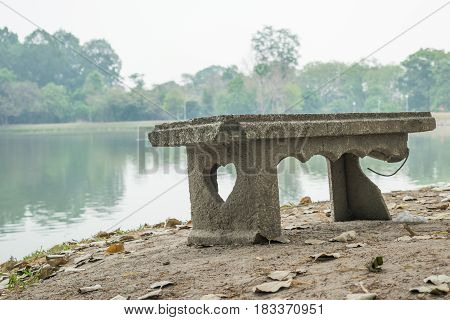 broken old marble bench in nature background